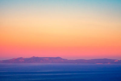 Scenic view of sea against romantic sky at sunset