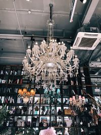 Low angle view of illuminated chandelier in shopping mall