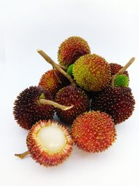 Close-up of fruit over white background