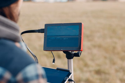 Rear view of man using mobile phone