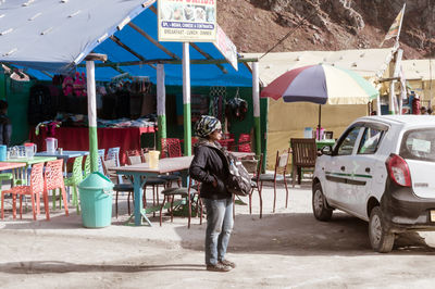 Rear view of man standing on street in city