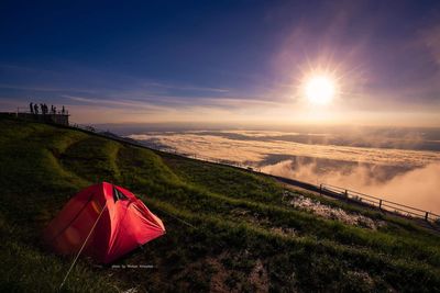 Scenic view of tent against sky during sunset