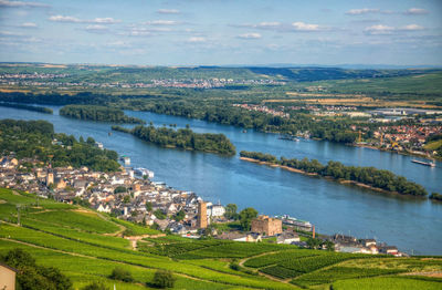 High angle view of townscape by river against sky