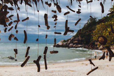 Close-up of religious equipment hanging at beach