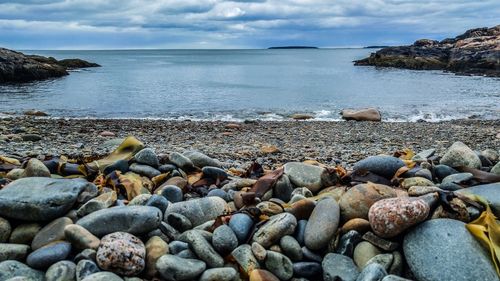 Rocks on beach against sky