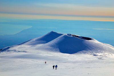 Scenic view of snowcapped mountain against sky during sunset