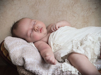 Close-up of baby sleeping on bed