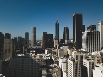 Modern buildings in city against clear sky