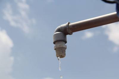 Low angle view of water pipe against sky