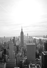 Aerial view of buildings in city against sky