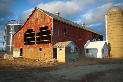 Houses on field against sky