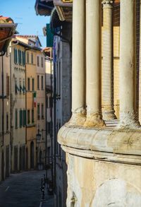 Ancient columns of a church on background of medieval street town of arezzo, tuscany