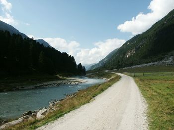 Scenic view of wooden country road against clear sky