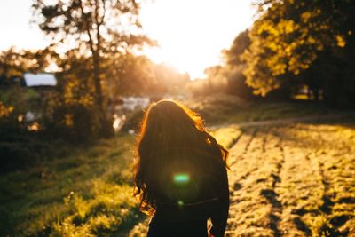 Silhouette of woman on tree trunk