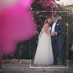 Couple holding pink flower in park