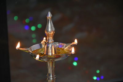 Close-up of illuminated oil lamp