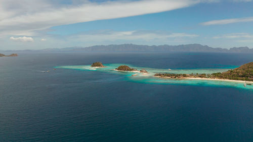 Aerial seascape island with white beach. bulog dos. tourist boats on coast tropical island. 