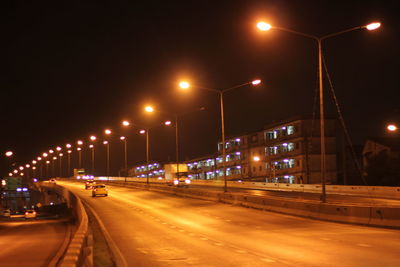 Cars on road in city at night