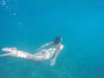 High angle view of woman swimming in adriatic sea on sunny day