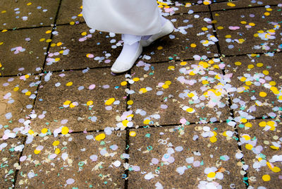 Low section of woman walking on autumn leaves