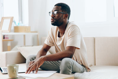 Young man using laptop while sitting at home