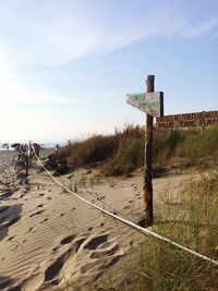 Lifeguard hut on land against sky