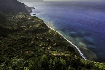 Scenic view of sea by buildings