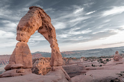 Scenic view of rock formation against cloudy sky