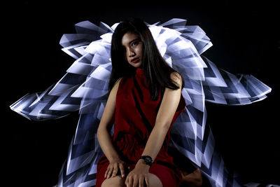 Portrait of young woman in light painting