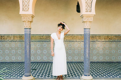 Woman standing against wall