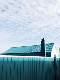 Low angle view of building against cloudy sky