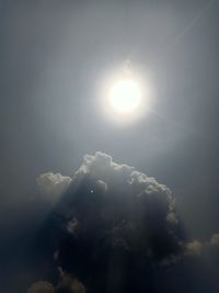 Low angle view of bright sun in sky