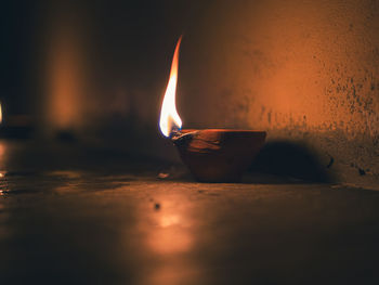 Close-up of burning earth oiled lamp