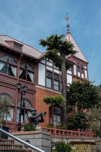 Exterior of building by trees against sky