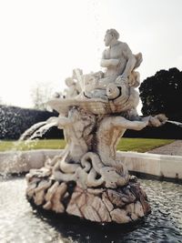 Statue of fountain in park against sky