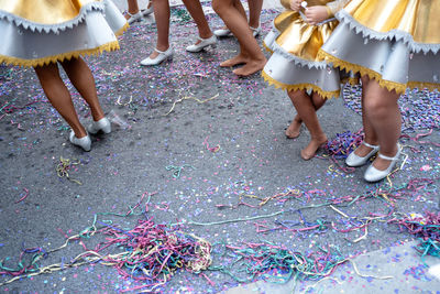 Low section of people dancing on road during carnival