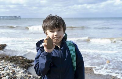 Boy standing on beach