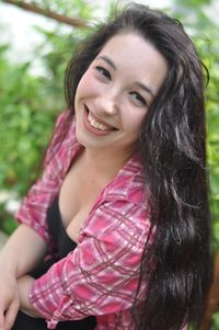 Portrait of smiling young woman with black hair