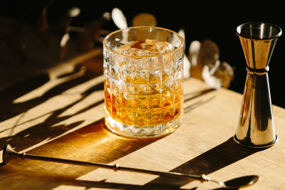 Close-up of glass with bourbon whiskey on table