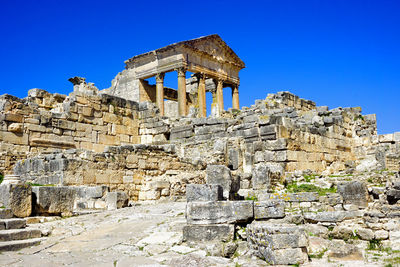 Old ruins of temple against clear blue sky