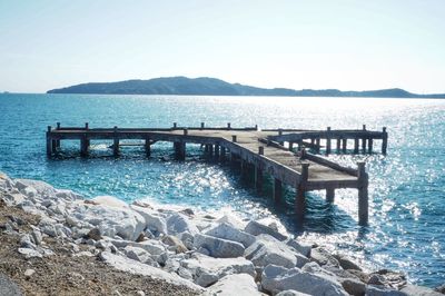 Pier on sea against clear sky