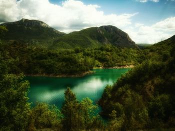 Scenic view of lake and mountains against sky