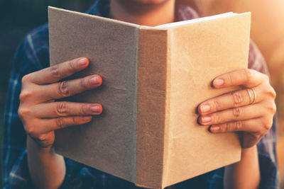 Close-up of hand holding book