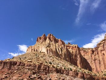 Low angle view of rock formation against blue sky