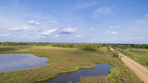 Scenic view of agricultural field against sky