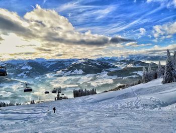 People on snowcapped mountain against sky