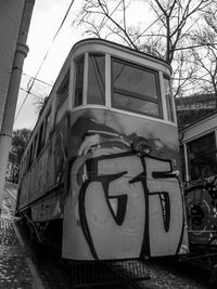 Graffiti on train against sky