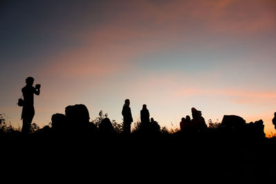 Silhouette people against sky during sunset