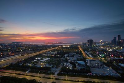 High angle view of illuminated buildings against sky during sunset