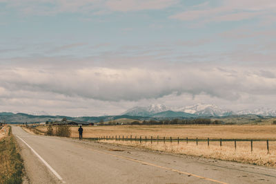Empty road along countryside landscape